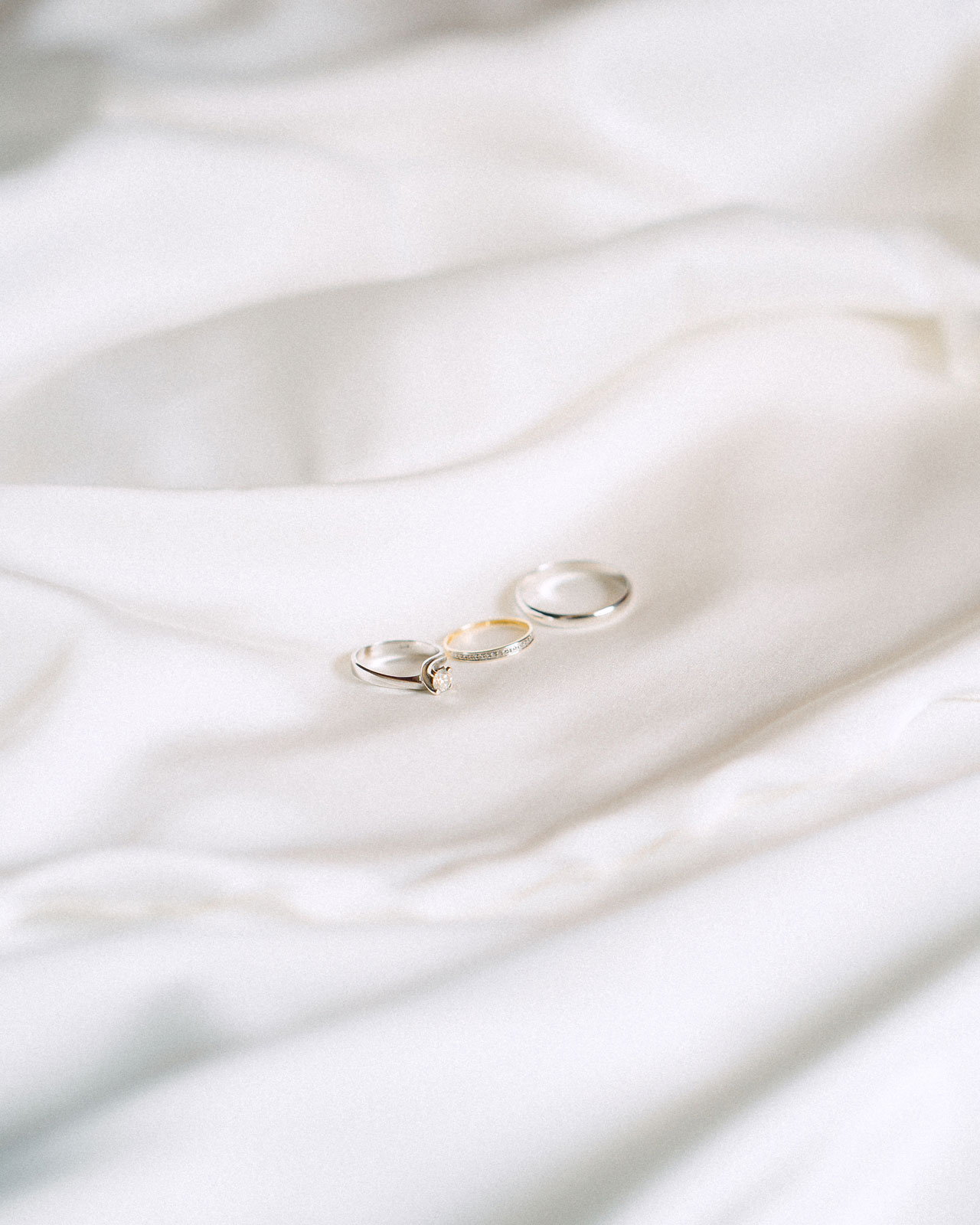 wedding-rings-high-angle-view-cloth-white-background